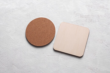 Cork and white coasters for drinks on white concrete background