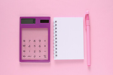 Transparent calculator and notebook with pen on pink background. Business concept.