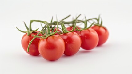 Fresh cherry tomatoes arranged on a clean white surface, great for food styling or photography props