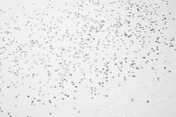 sparkles silver stars on white background with text place- Image