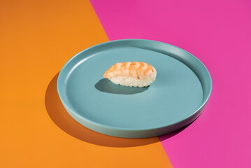 A plate with a piece of sushi on it
