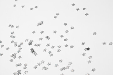 sparkles silver stars on white background with text place- Image