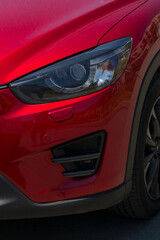 Leftist front wheel and headlight. Replicas of Russian cars. Halogen lighting at the red car.