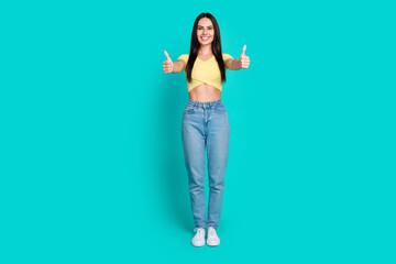 Full size photo of nice young woman show thumb up wear top isolated on teal color background