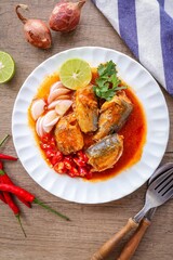 Mackerel in tomaro sauce ,Spicy Canned Mackerel salad, canned fish,Tinned fish in a white plate, top view food table