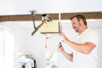 A men inspector or Fixing a garage door