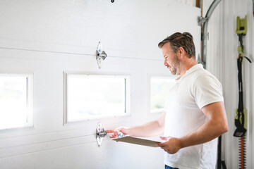 A men inspector or Fixing a garage door