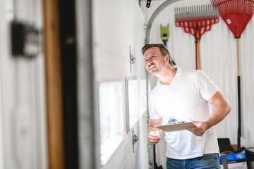 A men inspector or Fixing a garage door