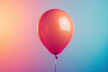 Vibrant orange balloon against a colorful gradient background