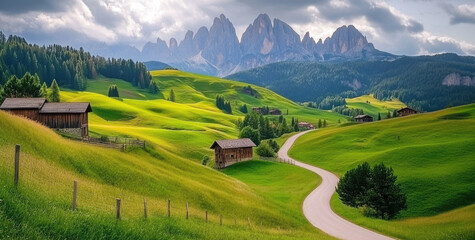 Obraz premium Beautiful green grassy hills with wooden houses and a road leading to mountains in the Dolomites, Italy.