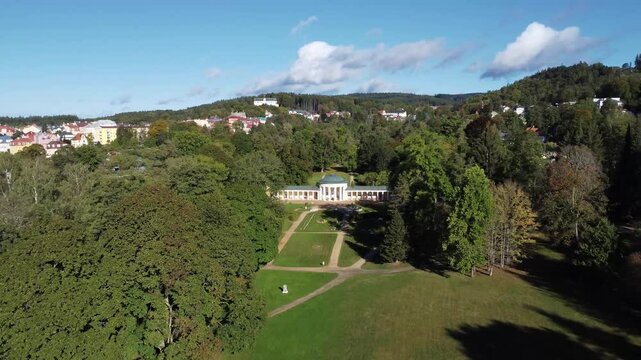 Czech spa town Marianske Lazne (Marienbad) - drone flight through the spa park from the pavilion of Rudolf Spring to the small colonnade of Ferdinand Spring