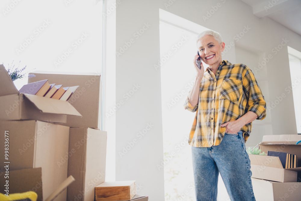 Canvas Prints Photo of nice aged woman speak phone wear checkered shirt relocate move new apartment indoors