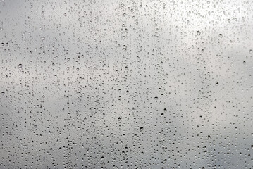 raindrops on window glass close-up, background