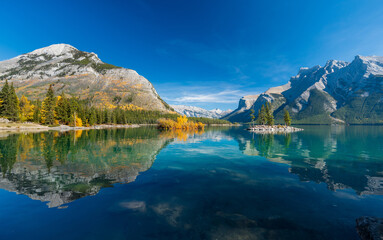 Banff National Park Lake Minnewanka autumn landscape. Alberta, Canada. Majestic mountains, forests...