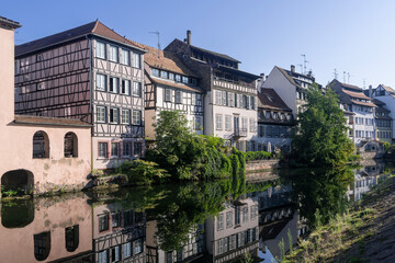 Strasbourg, France - August 28th 2024 : View of the Tanner's Quarter with half-timbered buildings and the Ill river and reflections on the water.