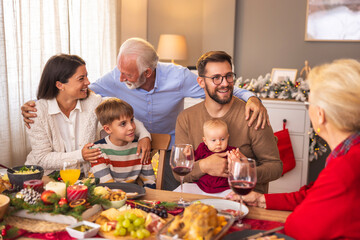 Happy multi-generation family having Christmas dinner at home