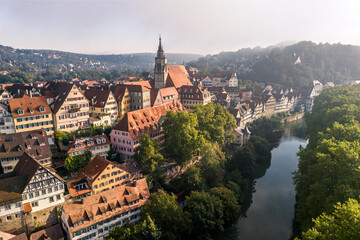 Aerial view of the old town of Tübingen and the Neckar River in the morning fog