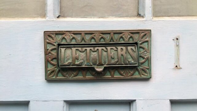 Vintage letterbox, mail box made of brass metal for home delivery by postman and couriers. Home architecture detail. 