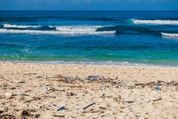 Garbage pollution on ocean sandy beach in Bali island.