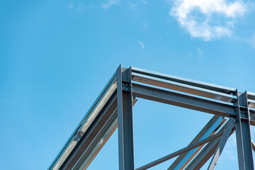 Steel Framework Rises Against Bright Blue Sky Showcasing Modern Architectural Design Techniques