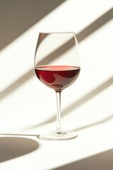 Elegant Red Wine Glass Against Modern Lighting - Perfect for Dining, Wine Tasting, or Design Projects
