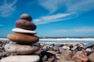 Balanced stones on a pebble beach. Background peaceful meditation and mindfulness. Mental health and meditation concept.