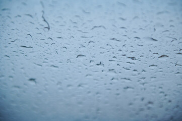 Raindrops on a Window During a Cloudy Day. Texture