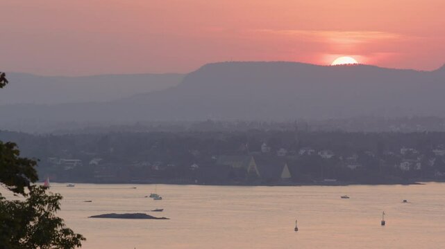 High angle sunset view over Oslofjord with boat traffic and Bygdoy peninsula