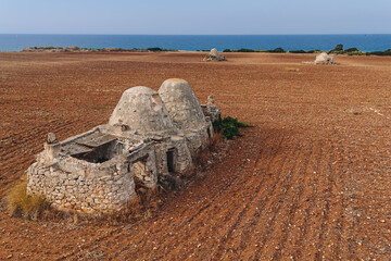 Old trulli houses near the coastline in Puglia
