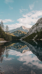 Fototapeta premium Majestic Mountain Reflections on Serene Alpine Lake Under Blue Sky