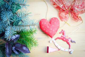 Christmas frame of spruce, natural christmas decorations on wooden background. Copy space. New Year lights. Flat lay.