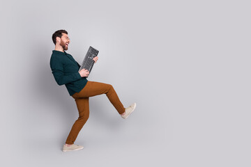 Photo of cool optimistic man wear stylish clothes have fun dance hold keypad isolated on gray color background