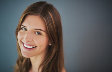 Naklejka premium Mockup space, portrait or happy woman with beauty, skincare or natural glow in studio. Antiaging treatment, smile or confident girl with facial health for cosmetics, shine or pride on gray background