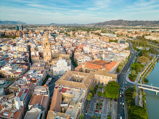 Obraz premium Aerial perspective of old town center of Murcia. Rooftops of Murcia. Medieval and historic travel destination in Spain. View of Cathedral of Murcia. River Segura 