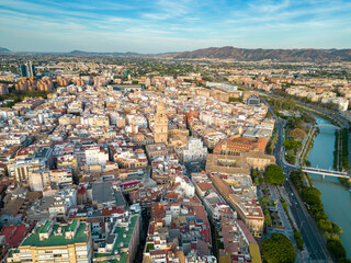 Obraz premium Aerial perspective of old town center of Murcia. Rooftops of Murcia. Medieval and historic travel destination in Spain. View of Cathedral of Murcia. River Segura 