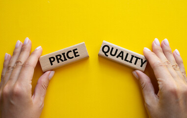 Price or Quality symbol. Concept word Price or Quality on wooden blocks. Businessman hand....
