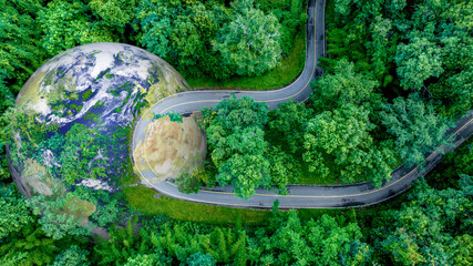 Obraz premium Electric car and EV electrical energy for environment, EV car on forest road with earth planet going through forest, Ecosystem ecology healthy environment, Electric car with nature, Save earth energy.