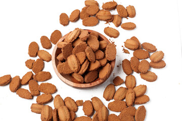 biscuits with coffee flavor, isolated on white background, on a wooden bowl, top view