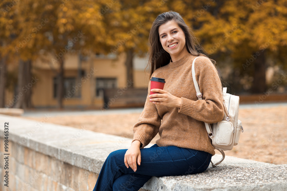 Wall mural casual portraif of caucasian pretty smiling young brunette woman 25-30 years old in brown knitted sw