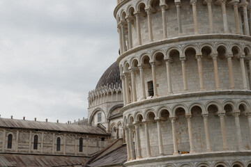 Close up view of the Leaning Tower of Pisa in the foreground and the Cathedral in the background -...