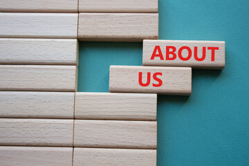 About us symbol. Wooden blocks with words About us. Beautiful grey green background. Business and...