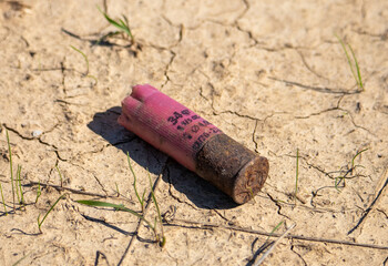 Close-up with an old hunting cartridge on the ground