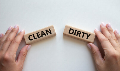 Clean or Dirty symbol. Concept word Clean or Dirty on wooden blocks. Man hand. Beautiful white background. Gender and Clean or Dirty concept. Copy space