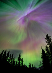 Aurora borealis filling sky with green and purple lights
