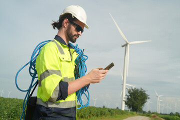 Maintenance engineer working at wind turbine farm