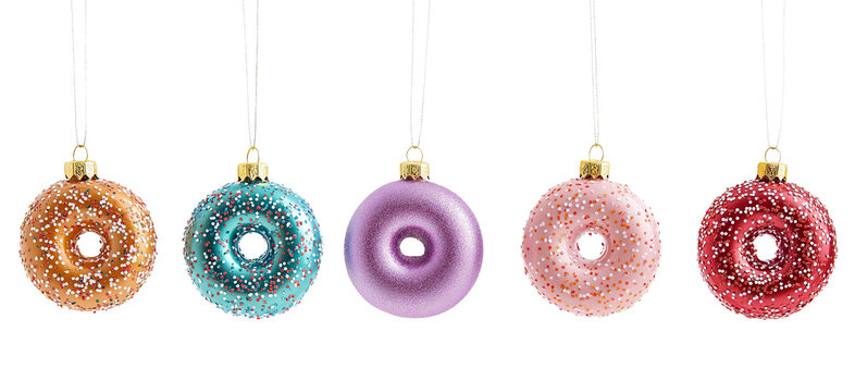 Colorful donut christmas ornaments with sprinkles cut on transparent background