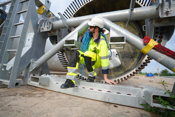 Maintenance engineer working at wind turbine farm