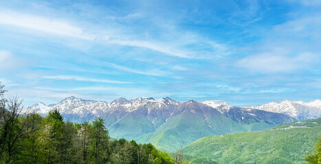 Beautiful panoramic landscape - view of Glade 960 with modern luxury hotels among the green mountains on a sunny summer day