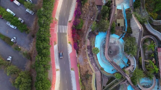 Drone flight over abandoned amusement park Tivoli World located in Benalmadena, Spain. Aerial view of water roller coaster attraction.