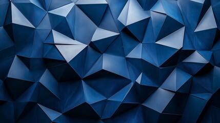 Obraz premium A blue wall with angular, abstract shapes in shades of grey and navy, resembling folded paper or origami forms